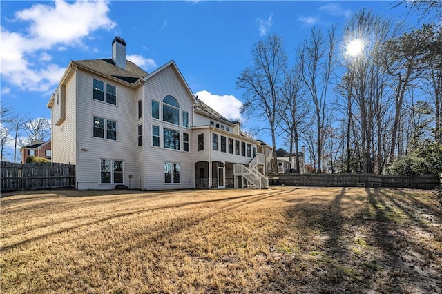 back of house with a lawn