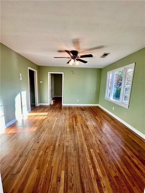 unfurnished room featuring hardwood / wood-style flooring and ceiling fan