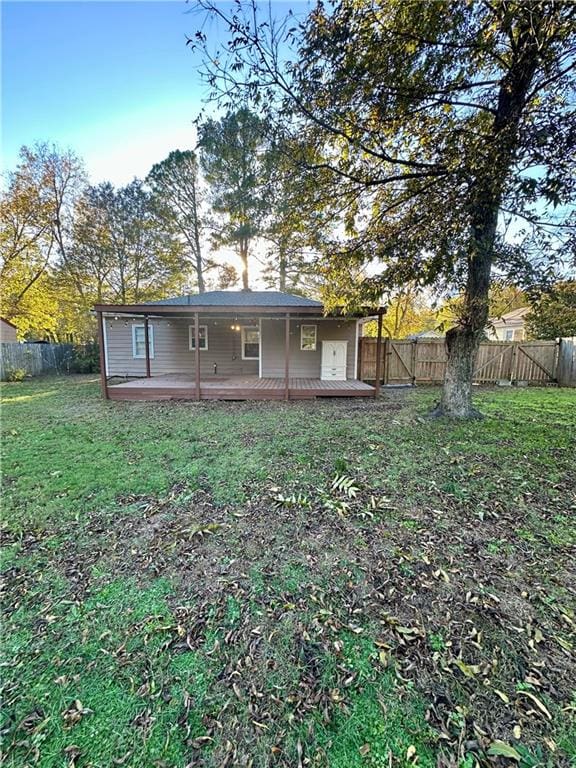 back of house with a yard and a deck