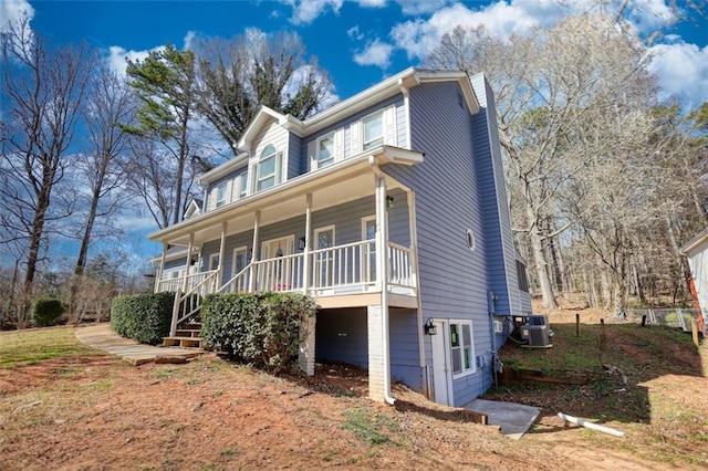 view of home's exterior featuring a porch and cooling unit