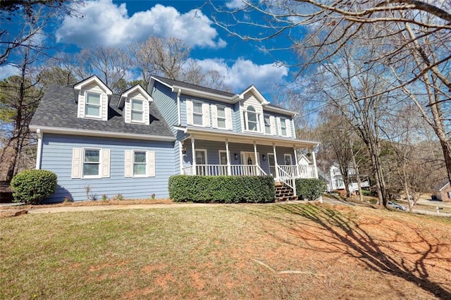 colonial-style house featuring a porch, a shingled roof, and a front lawn