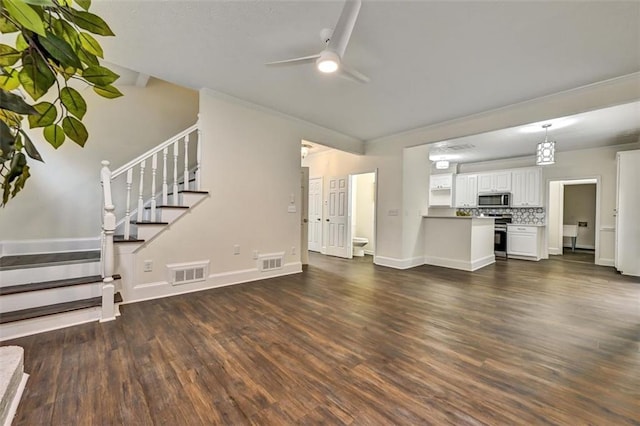 unfurnished living room featuring stairway, visible vents, and dark wood finished floors