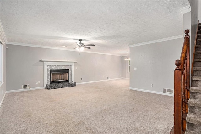 unfurnished living room with crown molding, a textured ceiling, ceiling fan, and carpet