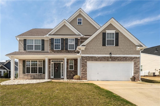 craftsman inspired home with concrete driveway, an attached garage, and a front lawn