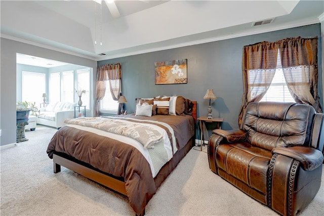 bedroom with baseboards, a raised ceiling, carpet flooring, and crown molding