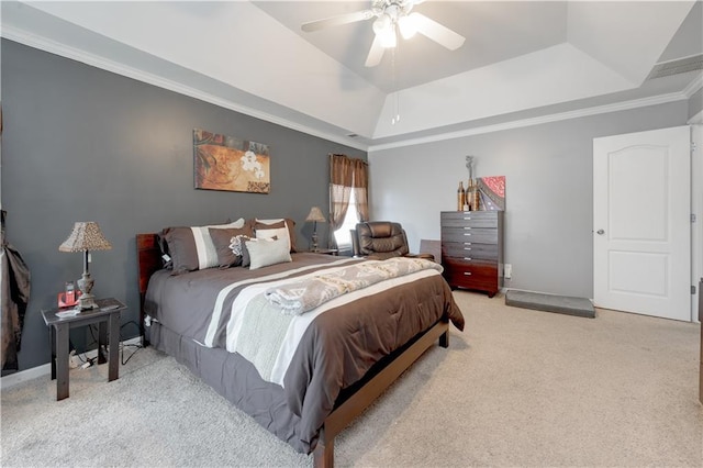 bedroom with a raised ceiling, light carpet, crown molding, and ceiling fan