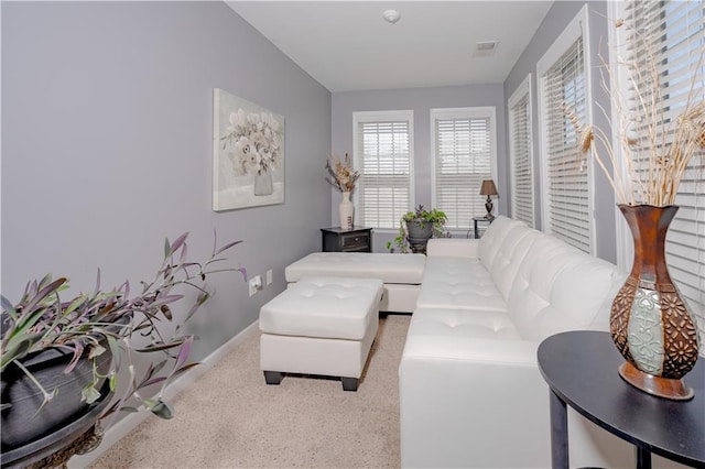 living area featuring visible vents and baseboards