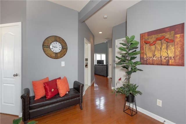 hallway featuring baseboards and wood finished floors