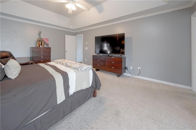 bedroom with light carpet, a ceiling fan, baseboards, a raised ceiling, and crown molding