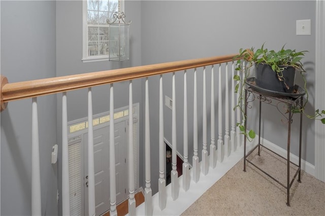 staircase with an inviting chandelier