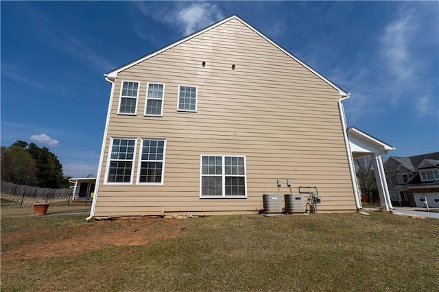 back of house with a yard and fence