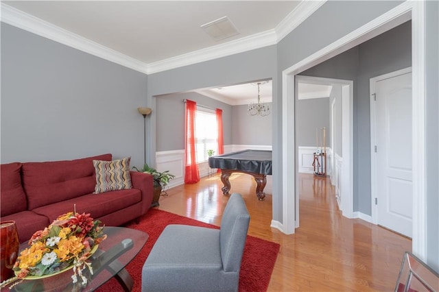 living area featuring billiards, wood finished floors, visible vents, and crown molding