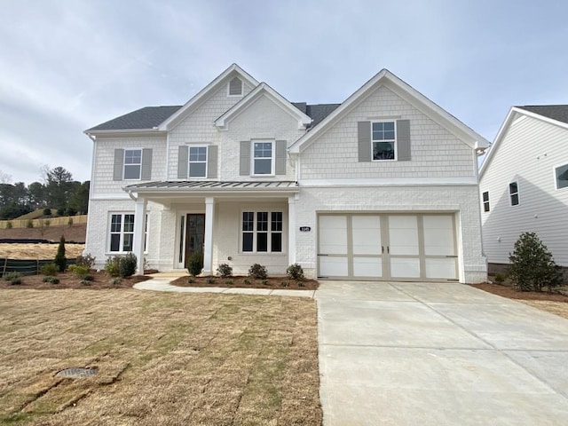 view of front of property featuring a garage and a front yard