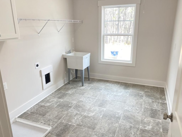 laundry area featuring laundry area, hookup for an electric dryer, and baseboards