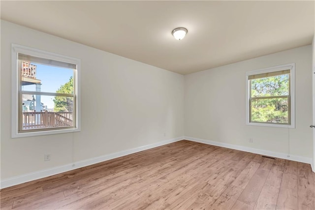 unfurnished room featuring light wood-style flooring and baseboards