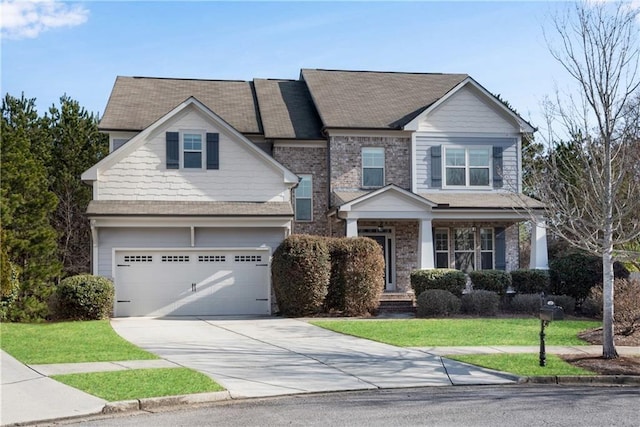 craftsman-style house with covered porch, concrete driveway, a front lawn, a garage, and brick siding