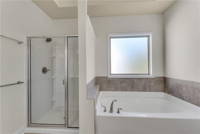 full bathroom featuring a stall shower and a garden tub