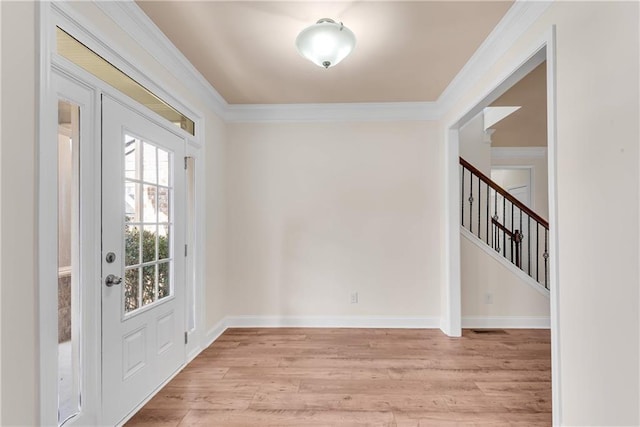 interior space with light hardwood / wood-style flooring and crown molding