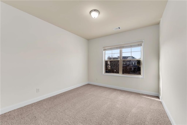 unfurnished room featuring light colored carpet, baseboards, and visible vents