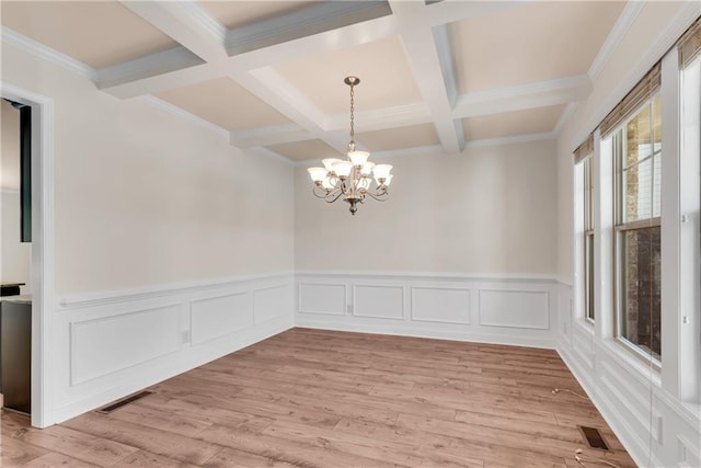 unfurnished room with beam ceiling, visible vents, and light wood finished floors