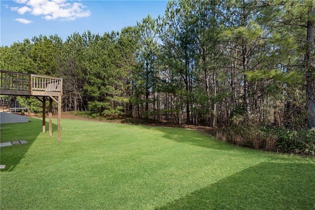 view of yard featuring a wooden deck