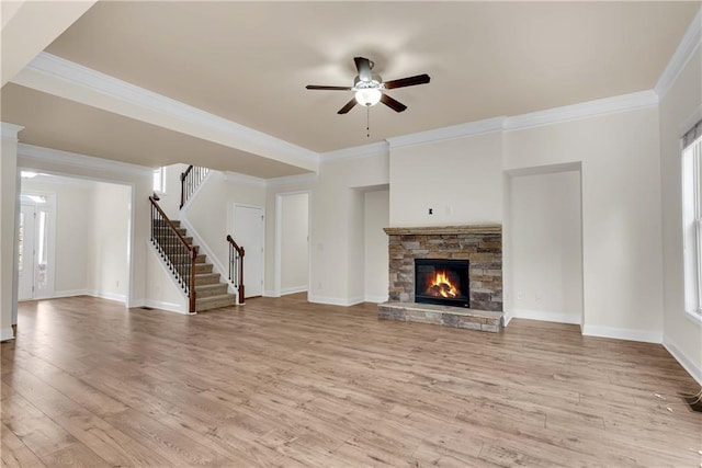 unfurnished living room featuring stairway, baseboards, wood finished floors, and crown molding