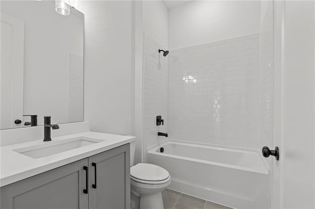 full bathroom with tiled shower / bath, vanity, and toilet