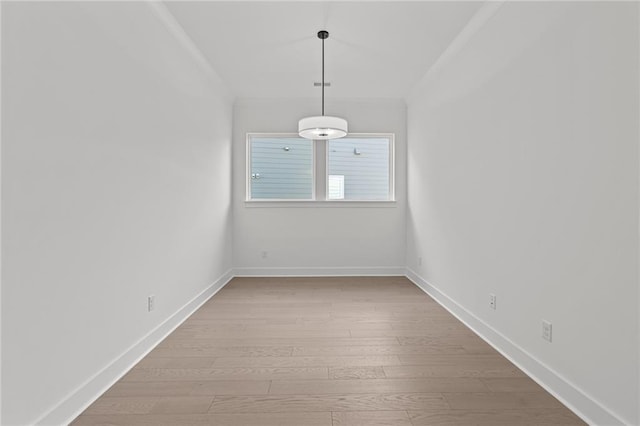 unfurnished room with crown molding and light hardwood / wood-style floors