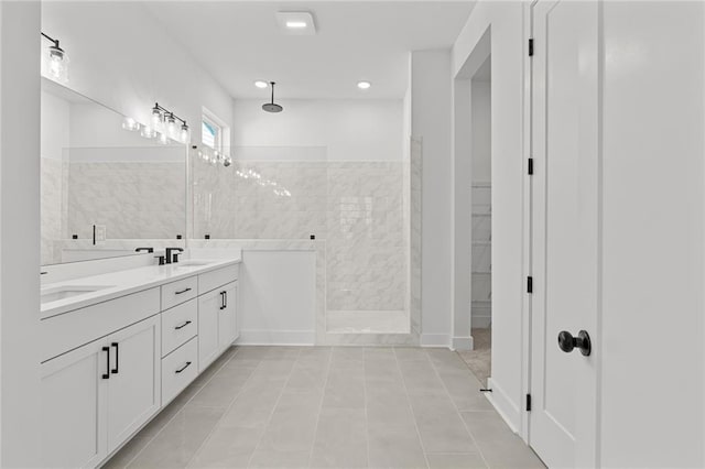 bathroom featuring vanity and tiled shower