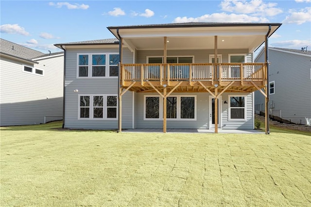 rear view of property with a patio and a lawn