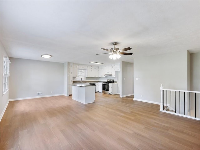 unfurnished living room featuring ceiling fan, light hardwood / wood-style floors, and sink