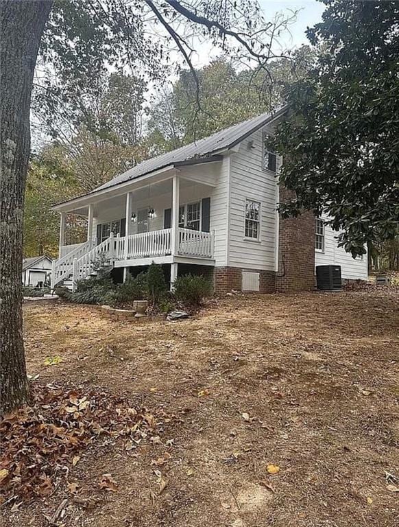 view of front of property featuring covered porch and central AC unit