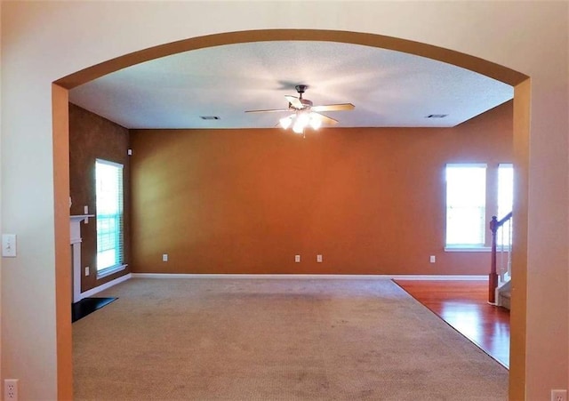 carpeted empty room featuring ceiling fan