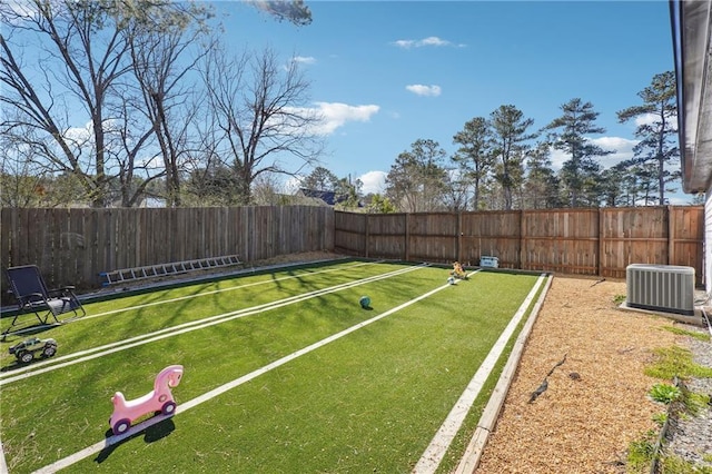 view of yard with cooling unit and a fenced backyard