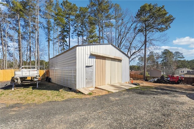 view of outbuilding with fence and an outdoor structure