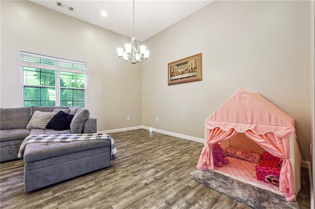 rec room with a chandelier, recessed lighting, wood finished floors, visible vents, and baseboards