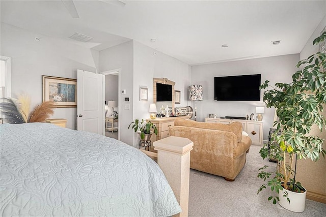 carpeted bedroom with visible vents and ceiling fan