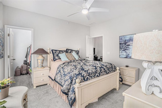 bedroom featuring visible vents, light colored carpet, and a ceiling fan