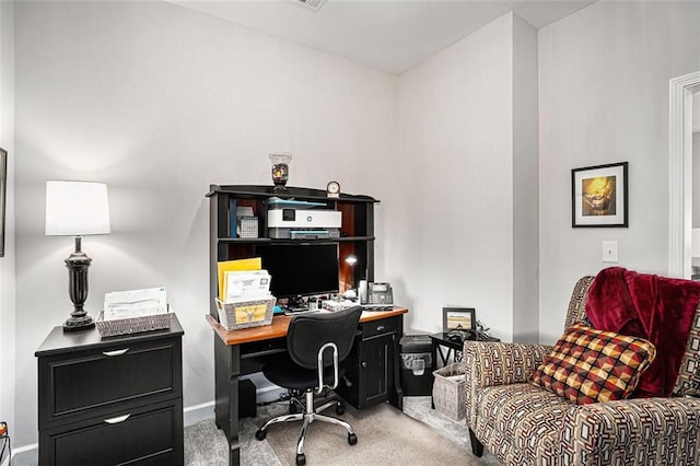 carpeted home office with baseboards