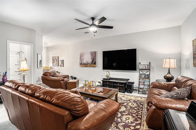 carpeted living area with visible vents and ceiling fan