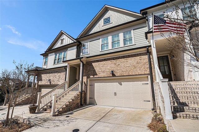 townhome / multi-family property featuring brick siding, an attached garage, concrete driveway, and stairs