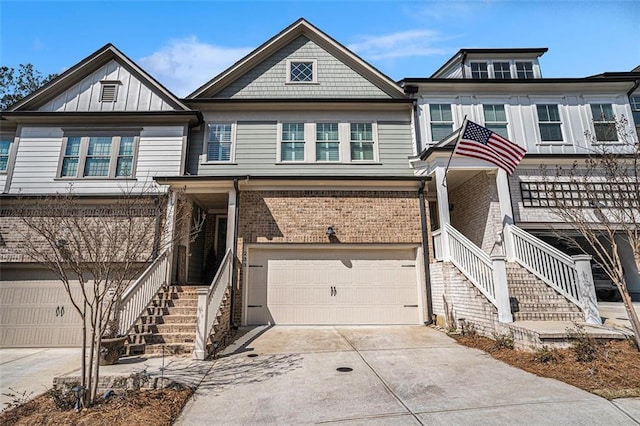 multi unit property featuring stairs, brick siding, concrete driveway, and an attached garage