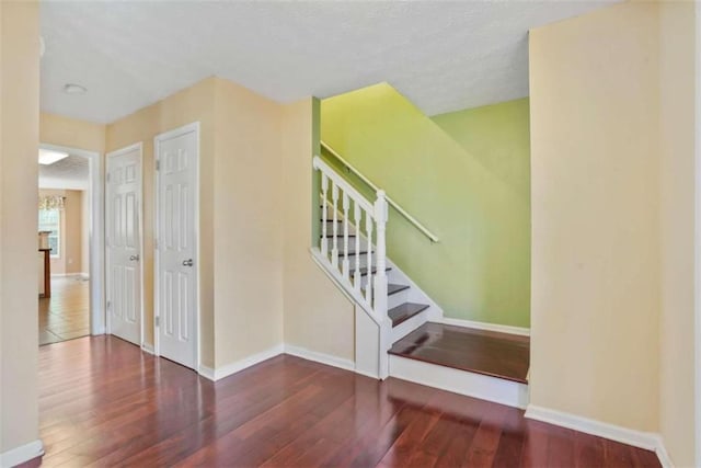 stairs featuring wood-type flooring