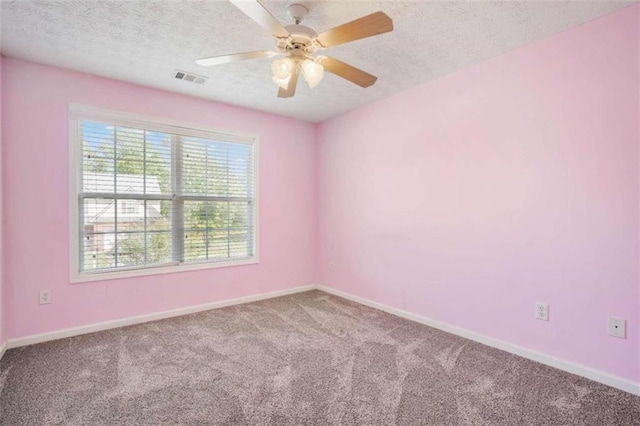 carpeted empty room featuring a textured ceiling and ceiling fan