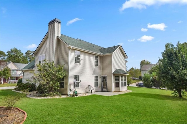 back of house with a yard and a patio area