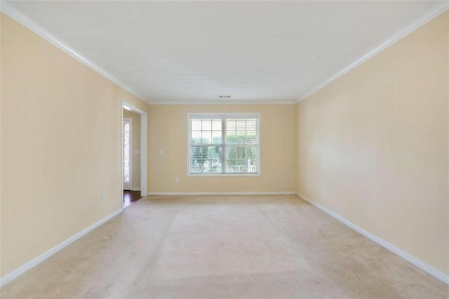 spare room featuring crown molding and light colored carpet