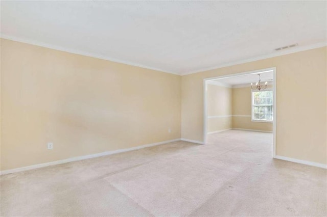 carpeted spare room featuring crown molding and a chandelier