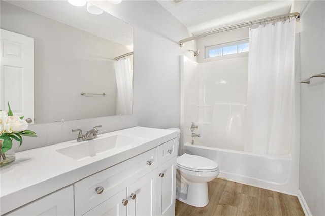 bathroom featuring shower / bath combination with curtain, vanity, wood finished floors, and toilet