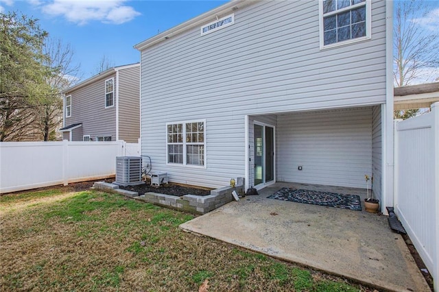 rear view of house featuring central AC, a patio, a lawn, and fence