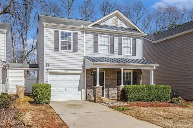 view of front facade with a garage, a standing seam roof, covered porch, and metal roof